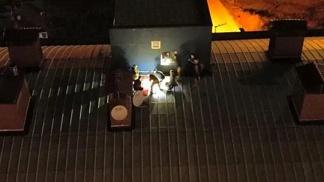 Genç kız çatıya çıktı, kurtarmak isteyenlerle birlikte mahsur kaldı